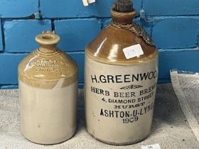 Two vintage stoneware advertising bottles.