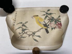 A 19th century Chinese scroll painting of a yellow bird in a pomegranate tree eating an insect,