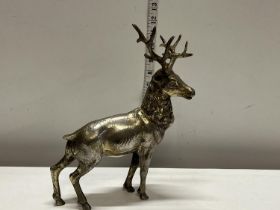 A hollow cast bronze stag with overlaid silver decoration