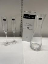 A pair of Dartington crystal champagne flutes and a boxed Dartington crystal wine decanter