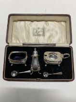 A quality cased hallmarked silver cruet set, complete with glass liners