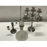 Two silver plated candlesticks and a glass decanter