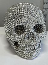 A silvered skull figure