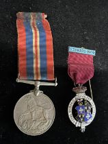 A silver masonic medal and a WW2 medal
