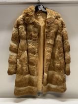 A ladies fur coat, no size slight tear