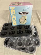 A boxed set of traditional scales and three new baking tins