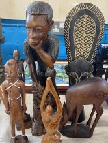 A selection of hand carved African themed figurines