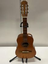 A 3/4 size acoustic guitar and stand, shipping unavailable