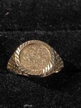 A 9ct gold ring with yellow metal coin 1.51g