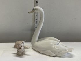 A Lladro Swan and a small Nao cherub