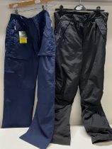 Two pairs of waterproof trousers one with tags