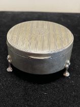 A hallmarked for Chester 1916 silver trinket box with three claw feet and monogram to cartouche,