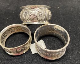 Three assorted hallmarked silver napkin rings, total weight 33g