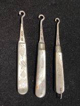 Three hallmarked silver Victorian bladed button hooks with silver handles