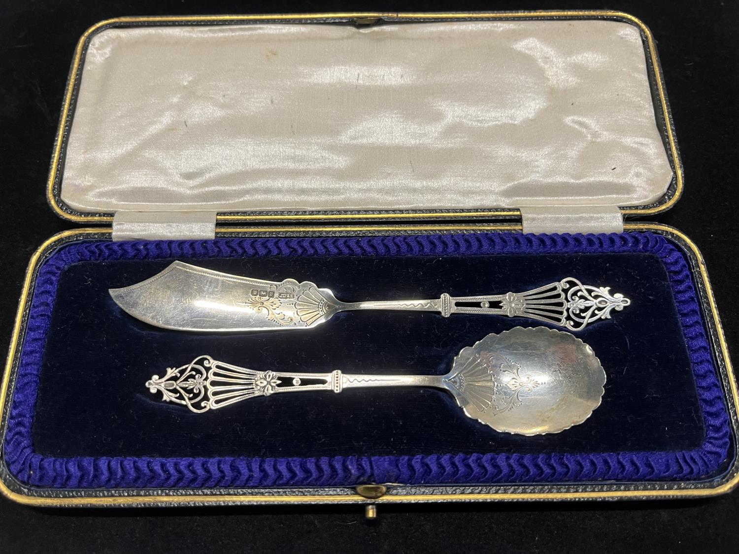 A hallmarked for Sheffield 1909 intricately worked knife and spoon set in original case by James