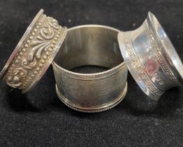 Three assorted hallmarked silver napkin rings, total weight 60g