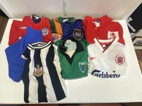 A box of assorted sized adult football shirts