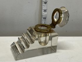 A antique glass and brass inkwell