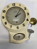 A vintage Smiths Enfield bakelite wall clock with key and pendulum