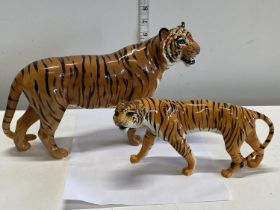 One large and one smaller Beswick tiger figurines