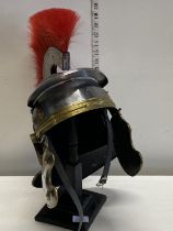 A good quality reproduction Roman Centurion helmet on hat stand