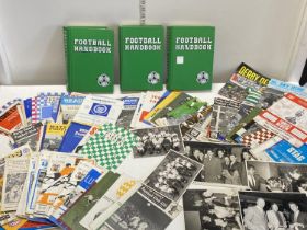 Three vintage football handbooks and a hundred assorted vintage football programmes,