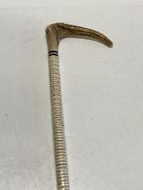 A antique horn handled and vertebrae walking cane, shipping unavailable