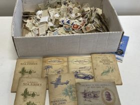 A vast collection of loose cigarette cards and albums