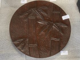 A Japanese carved wooden roundel with bamboo decoration with signature and marks to reverse