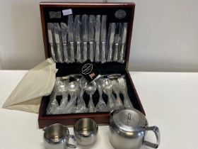 A cased set of unused Cooper Ludlam silver plated cutlery and a stainless steel tea service