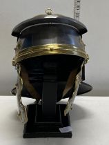 A good quality reproduction Roman helmet on hat stand