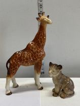 A Melba ware giraffe and lion cub figure