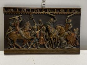 A handmade ceramic plaque depicting medieval crusaders