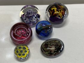 A selection of assorted paperweights including Caithness and other signed paperweights