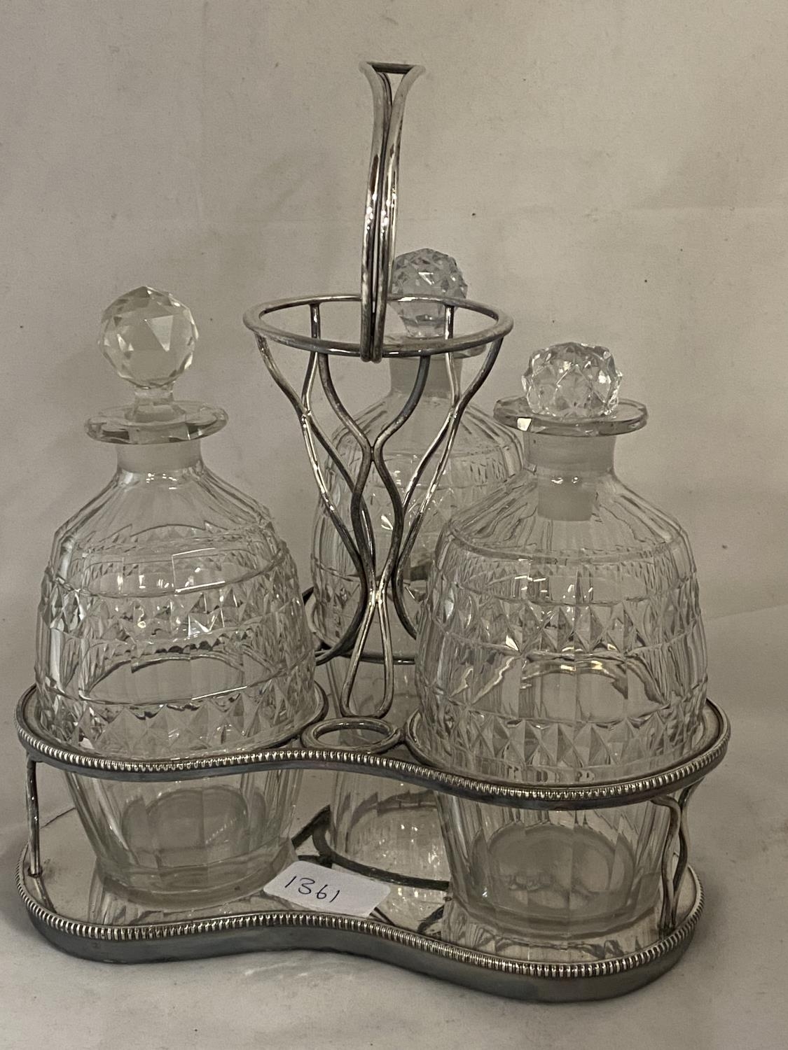 A chrome and glass three bottle decanter set a/f