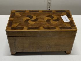 A vintage wooden musical box with parquetry decoration