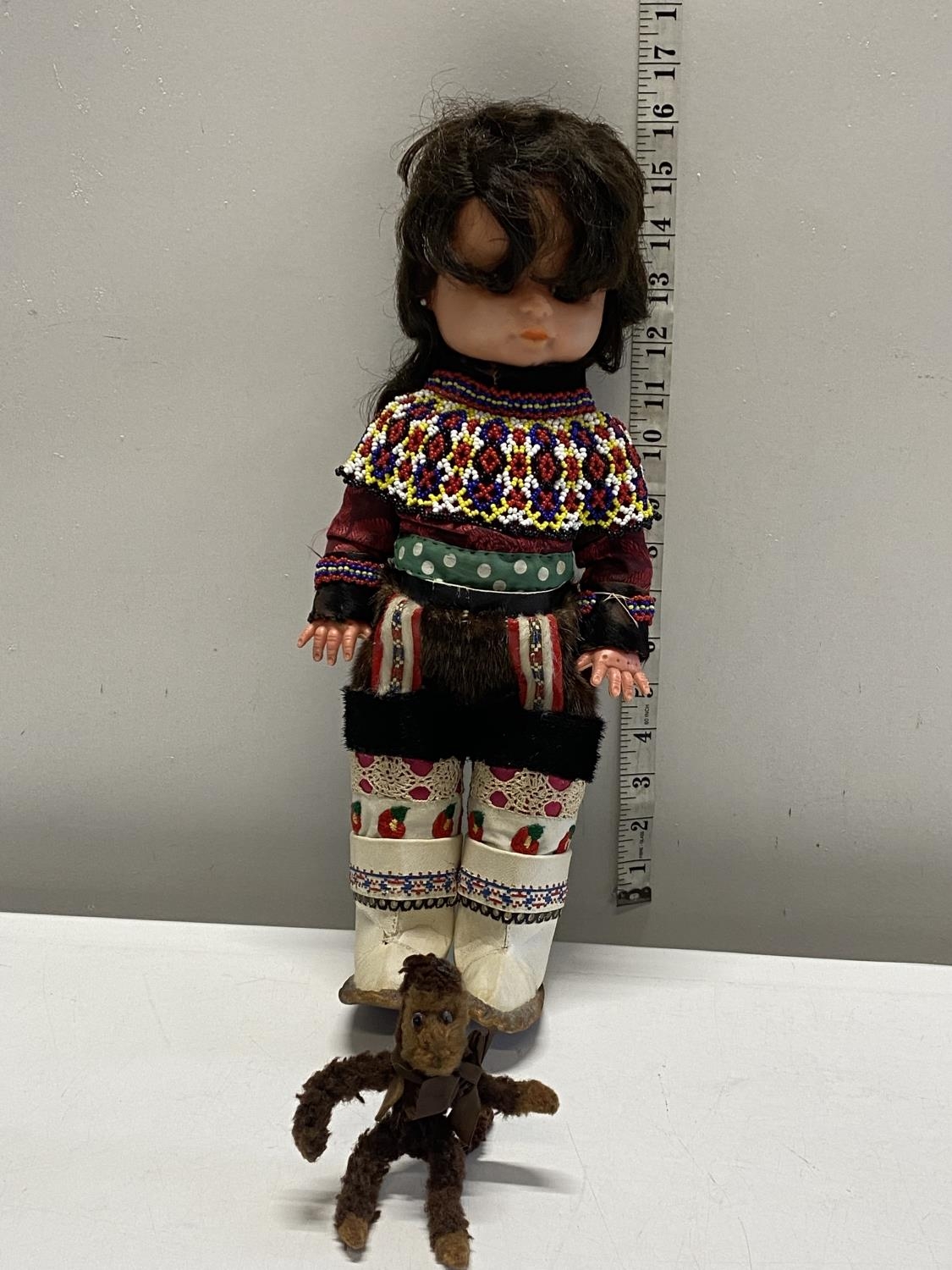 A vintage Inuit doll and monkey