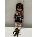A vintage Inuit doll and monkey