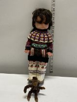 A vintage Inuit doll and monkey