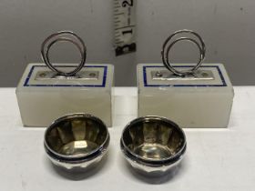 Two small sterling silver salts and a pair of vintage place card holders