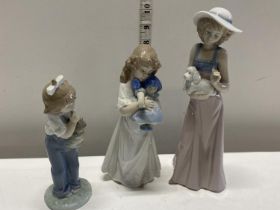 Three assorted Nao figurines