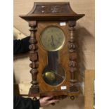 A large Vienna style mahogany cased wall clock with brass dial, key and pendulum, shipping