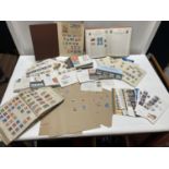 A large selection of assorted first day covers, stamp albums and other