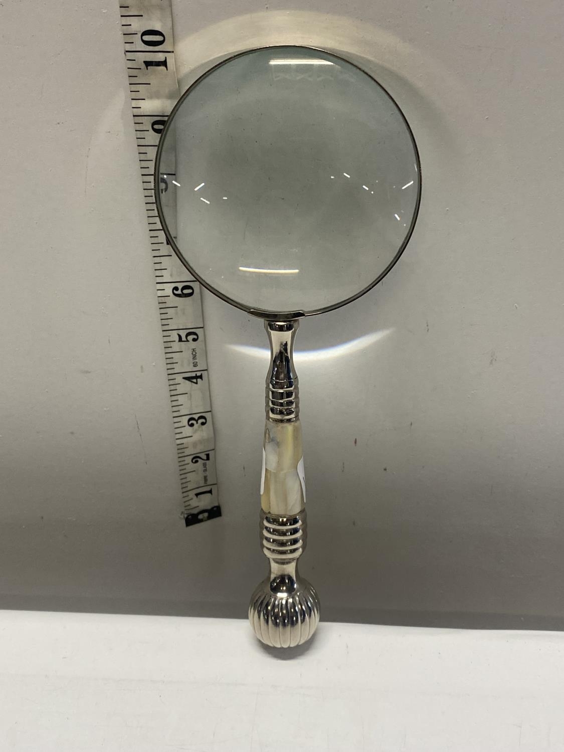 A large silver plated and MOP handled magnifying glass