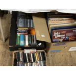 A box of mixed genre LP records, cassettes and CD's, shipping unavailable