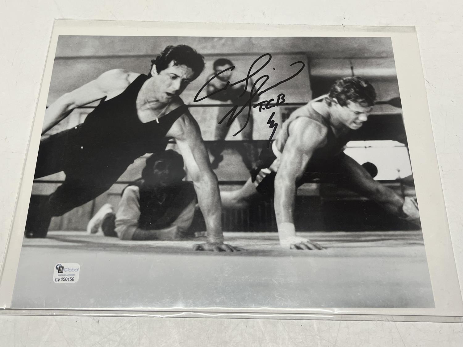 A signed photograph depicting Sylvester Stallone with unknown signature