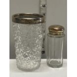 A hallmarked silver topped cut glass beaker and a small silver topped bottle