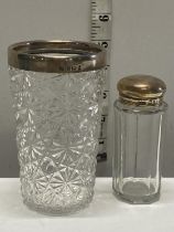 A hallmarked silver topped cut glass beaker and a small silver topped bottle