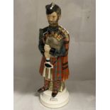 A musical porcelain decanter in the form of a bagpiper, H37cm