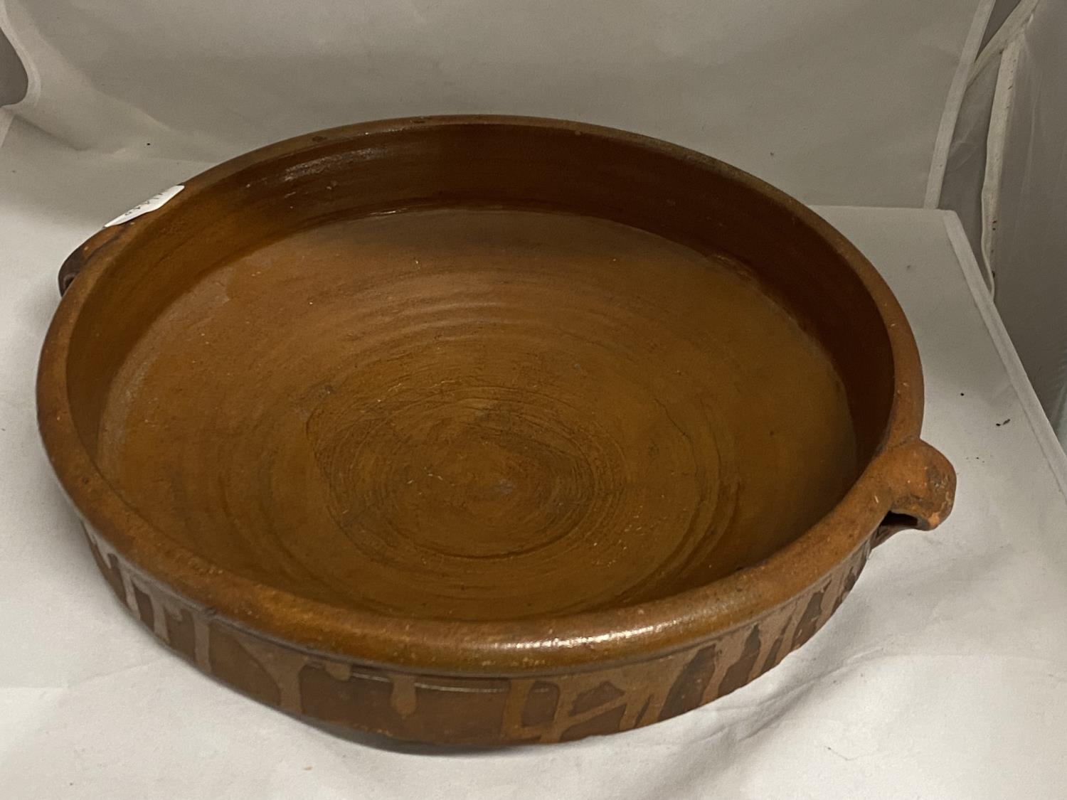 A Victorian terracotta and brown glazed cooking vessel d34cm, signed J POLLS shipping unavailable
